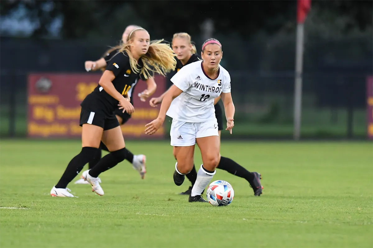 Winthrop women's soccer player dribbling